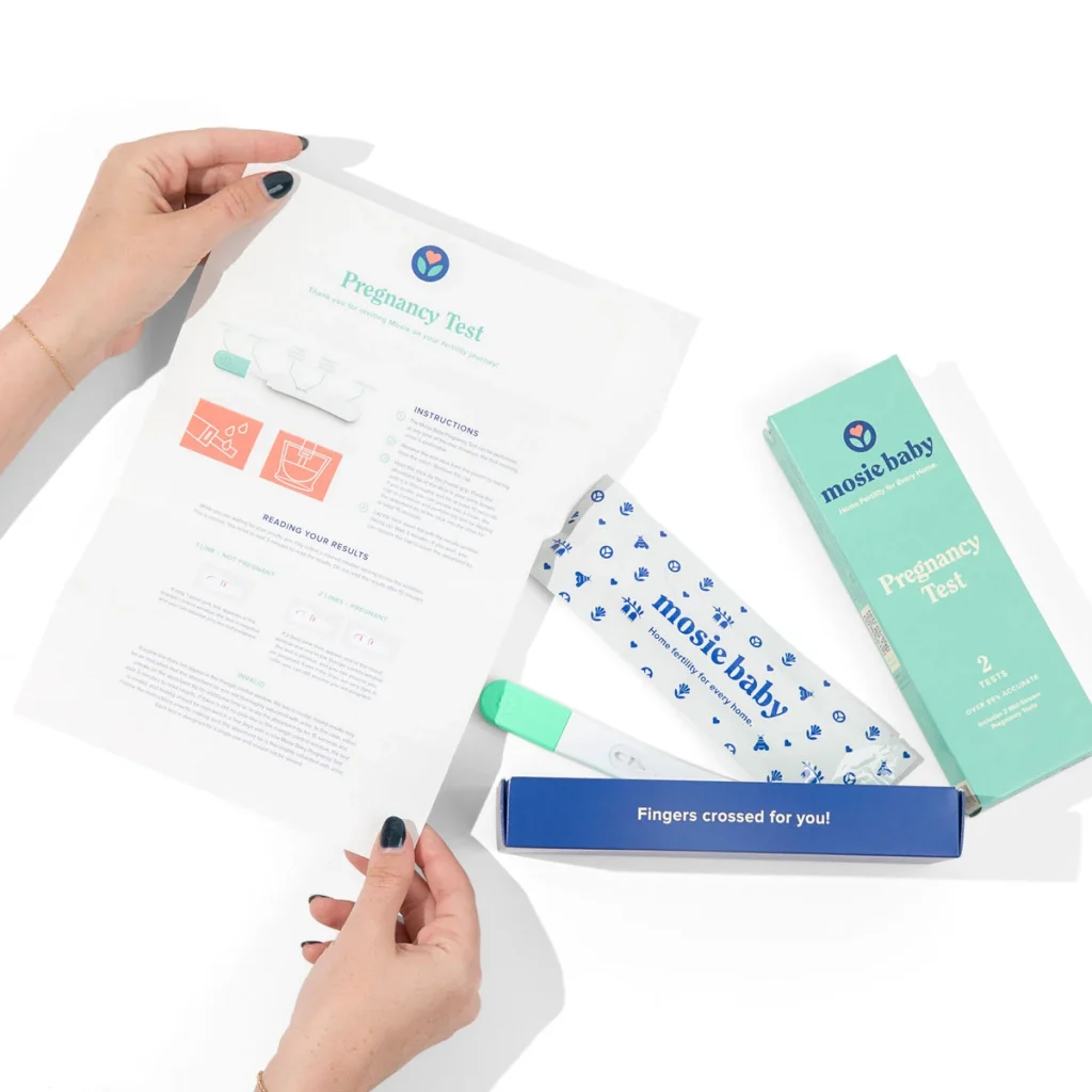 pregnancy test kit with instructions, test device, and packaging on a white background