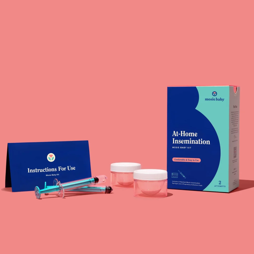 at-home insemination kit with syringes, collection cups, and instructions on a pink background